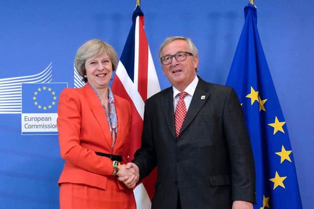 British Prime Minister Theresa May with European Union Commission President Jean-Claude Juncker before meeting at the European Union Commission headquarter in Brussels. Picture: Getty Images)