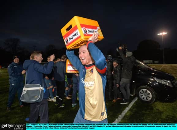 East Kilbride Captain Barry Russell celebrates with beer presented by Ajax club officials. Picture: Getty Images