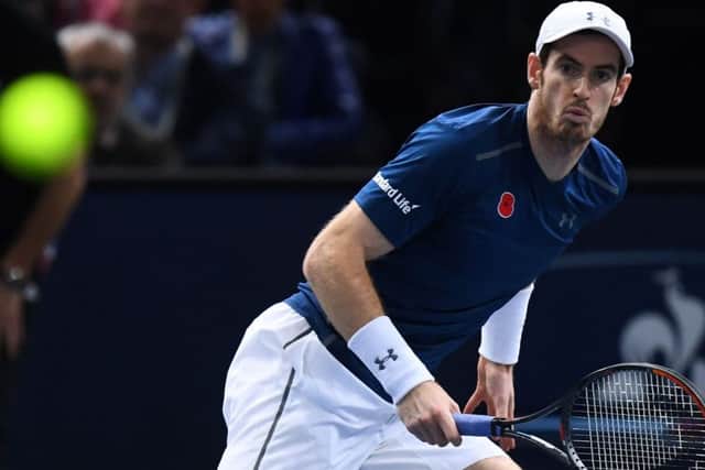 Andy Murray returns the ball to John Isner during his victory in Paris yesterday. Picture: AFP/Getty.
