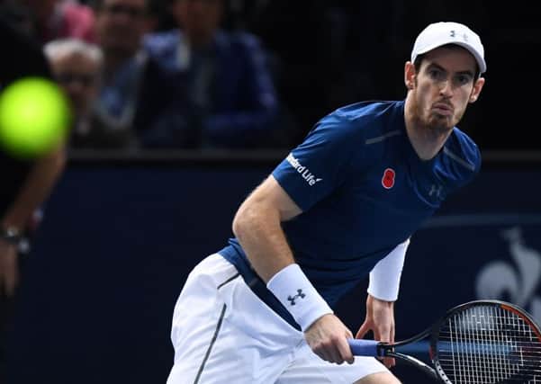 Andy Murray returns the ball to John Isner during his victory in Paris yesterday. Picture: AFP/Getty.