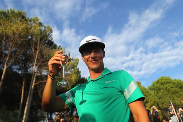 Thorbjorn Olesen of Denmark celebrates with a glass of bubbly after his closing round of 69. Picture: Getty.