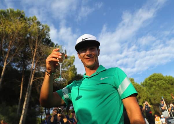 Thorbjorn Olesen of Denmark celebrates with a glass of bubbly after his closing round of 69. Picture: Getty.