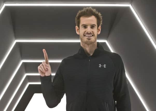Andy Murray holds up his finger to show he is world No. 1 after winning the final of the Paris Masters against John Isner of the United States in three sets at the Bercy Arena in Paris. Picture AP