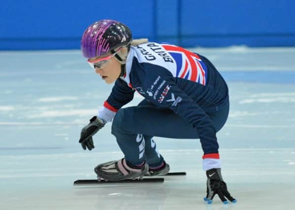 Scotland's Elise Christie struck gold and set two British records at the World Cup event in Calgary Canada.