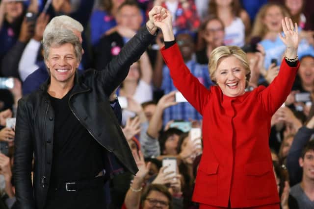Hillary Clinton and Jon Bon Jovi gesture to the crowd at North Carolina State  for the final campaign stop before election day. Picture: AFP/Getty Images