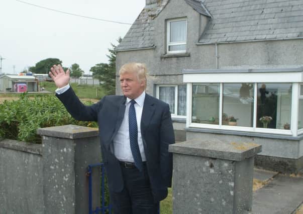 Donald Trump poses for photographers during a visit to his late mother's house on Lewis in 2008
