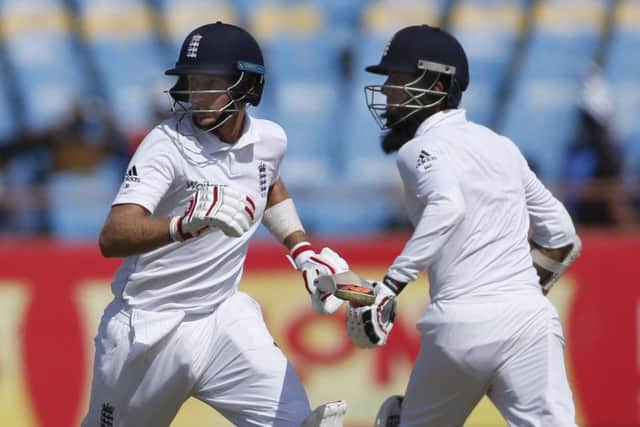 England batsmen Joe Root, left, and Moeen Ali run between the wicket during the first day of the first Test in Rajkot. Picture: AP