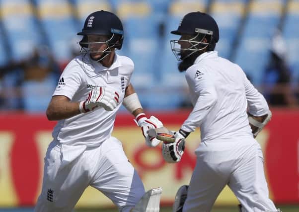 England batsmen Joe Root, left, and Moeen Ali run between the wicket during the first day of the first Test in Rajkot. Picture: AP