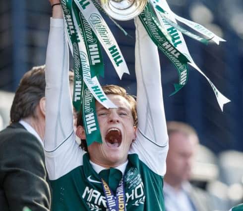 Liam Henderson lifts the Scottish Cup.  Picture: Robert Perry