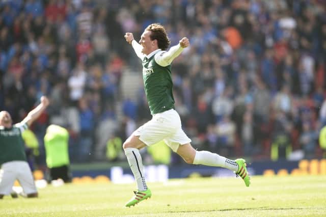 His cup runneth over: Liam Henderson at full-time  after the 3-2 win over Rangers. Picture: Greg Macvean