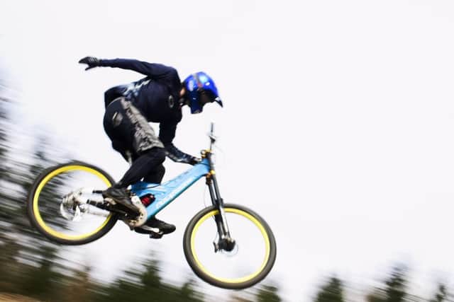 A mountain biker flies through the air at Glentress. Picture: Graham Riddell