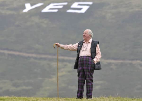 Peter de Vink stands overlooking the Yes sign at his estate near Temple. Photograph: Ian Rutherford