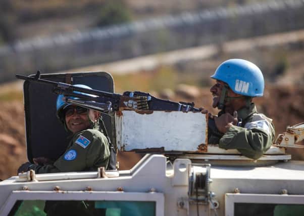 Peacekeepers from the United Nations monitor the border into Syria from the Israeli-occupied Golan Heights yesterday. Picture: AFP/Getty Images