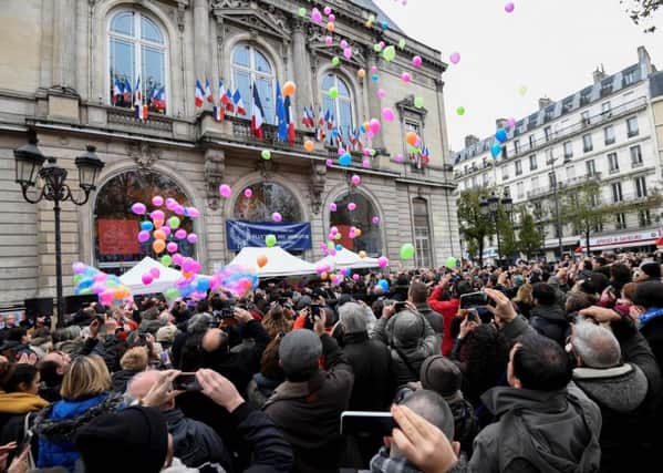 Balloons released in front of the city hall of the 11th arrondissement to mark the first anniversary of the Paris terror attacks. Picture: AFP/Getty Images