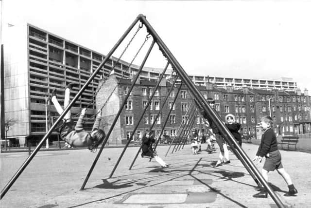 Children playing in a park in Henderson Gardens, Leith, with Cables Wynd House in the background. Picture: Denis Straughan/TSPL