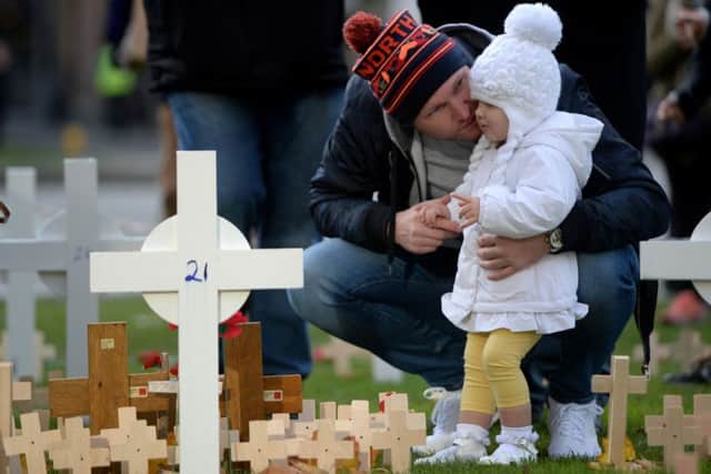 Chris Ward with his daughter Francesca,  at the Cenotaph in George Square, Glasgow.  Picture: SWNS