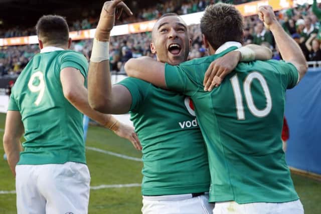 Simon Zebo, centre, celebrates with Jonny Sexton after scoring against New Zealand during Ireland's historic win over the All Blacks in Chicago. Picture: AP Photo/Kamil Krzaczynski