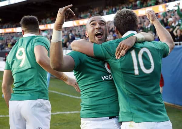 Simon Zebo, centre, celebrates with Jonny Sexton after scoring against New Zealand during Ireland's historic win over the All Blacks in Chicago. Picture: AP Photo/Kamil Krzaczynski