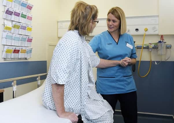 NHS Lothian occupational therapist Catriona Lyon assists and assesses a patient in A&E. Picture: Neil Hanna