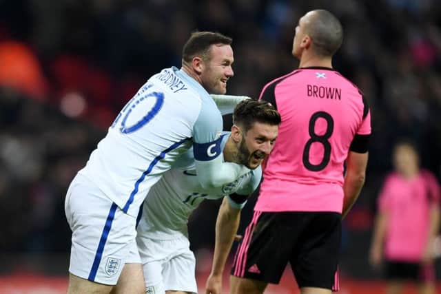 Adam Lallana celebrates with Wayne Rooney having put England 2-0 up. Picture: Getty