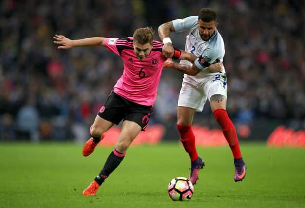 James Forrest and Kyle Walker battle for possession during the match. Picture: PA