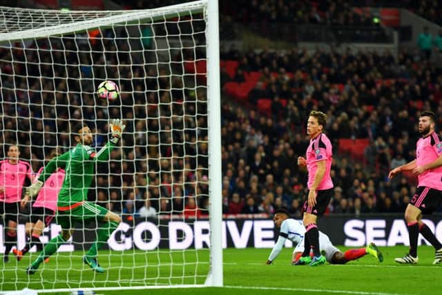 Scotland's players watch on as Daniel Sturridge heads England in front. Picture: Getty