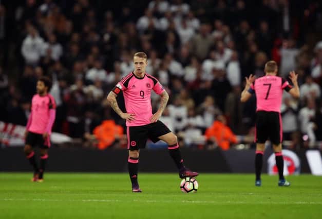 Leigh Griffiths stands dejected after England go 2-0 ahead in Scotland's loss at Wembley. Picture: PA