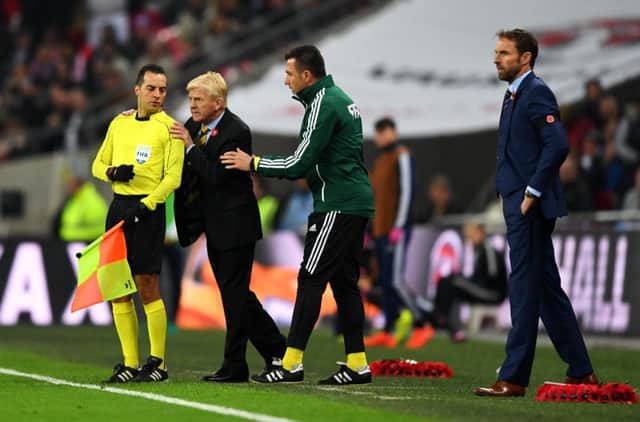 Hold on a minute: Gordon Strachan in discussion with assistant referee Bahattin Duran and fourth official Huseyin Gocek on Friday night. Picture: Shaun Botterill/Getty Images