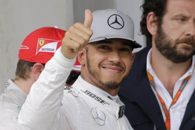 Lewis Hamilton gives a thumbs up after he clocking the fastest time in qualifying Brazilian Grand Prix. Picture: AP