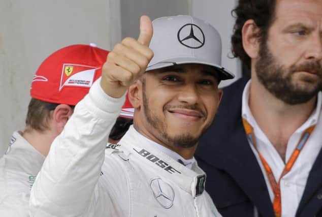 Lewis Hamilton gives a thumbs up after he clocking the fastest time in qualifying Brazilian Grand Prix. Picture: AP