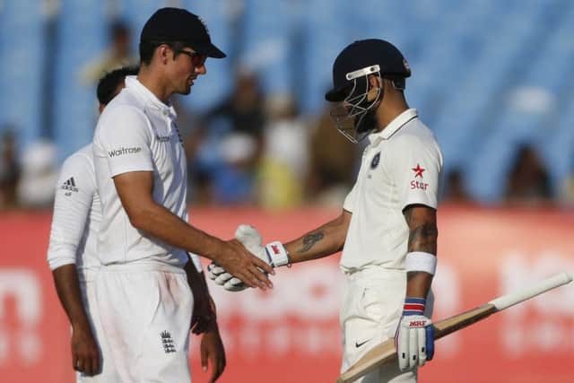 England captain Alastair Cook shakes hands with India counterpart Virat Kohli as the first Test in Rajkot ended in a draw. Picture: Rafiq Maqbool/AP