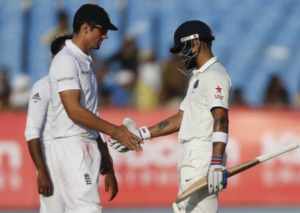 England captain Alastair Cook shakes hands with India counterpart Virat Kohli as the first Test in Rajkot ended in a draw. Picture: Rafiq Maqbool/AP