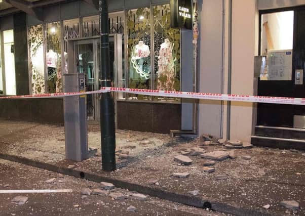 Debris from buildings are seen on a sidewalk past a cordon line in Wellington early on Monday. Picture: AFP/Getty Images