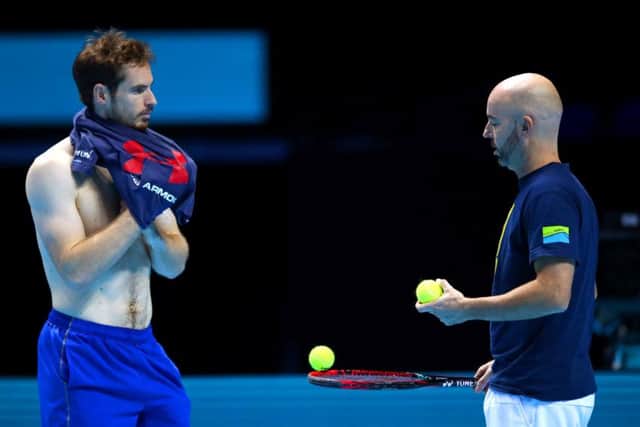 Andy Murray and coach Jamie Delgado discuss strategy during a practice session. Picture: Getty.