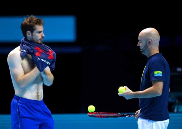 Andy Murray and coach Jamie Delgado discuss strategy during a practice session. Picture: Getty.