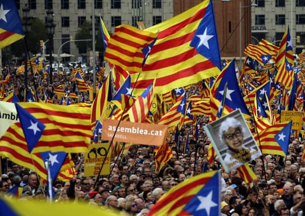 Pro-independence supporters wave "estelada" or pro independence flags, during a protest in Barcelona on Sunday. Picture: AP