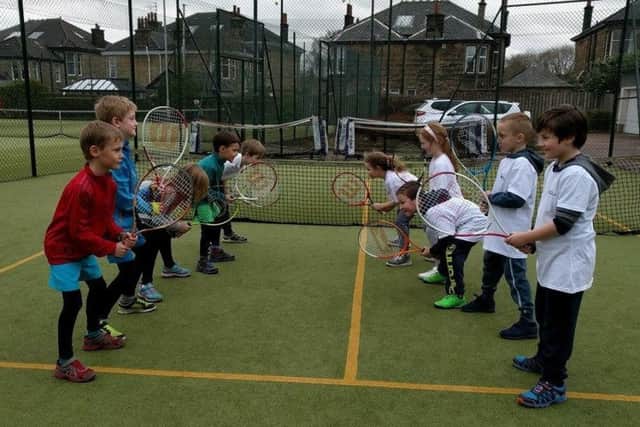 A group of young tennis enthusiasts are put through their paces at Drumchapel.