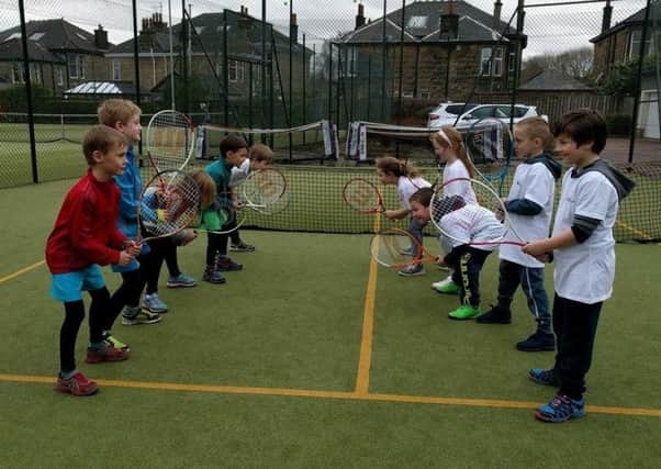 A group of young tennis enthusiasts are put through their paces at Drumchapel.