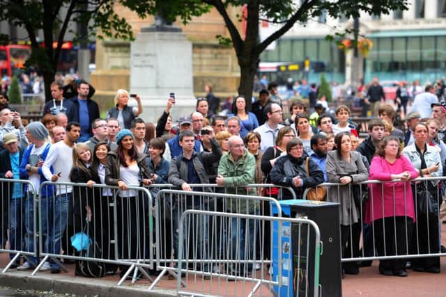 Members of the public gather in Cochrane Street, Glasgow, to watch the filming of World War Z in 2011. Picture: Robert Perry/TSPL