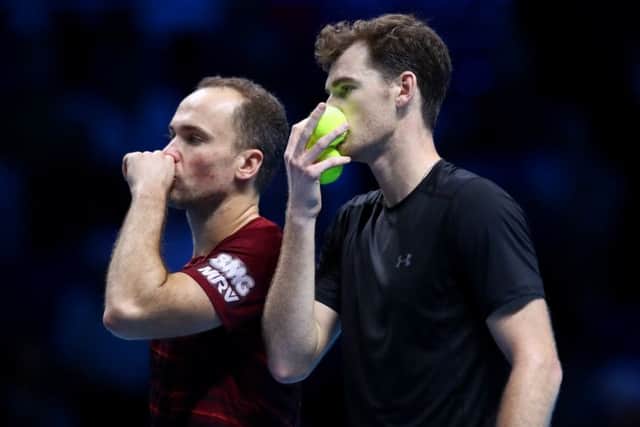 Jamie Murray, right, talks tactics with his partner Bruno Soares during their doubles win over the Bryan brothers. Picture: Getty