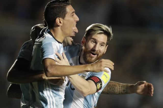 Argentina's Angel Di Maria, left, celebrates with teammate Lionel Messi during the win over Colombia. Picture: Natacha Pisarenko/AP