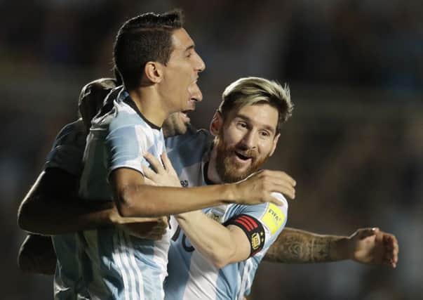 Argentina's Angel Di Maria, left, celebrates with teammate Lionel Messi during the win over Colombia. Picture: Natacha Pisarenko/AP