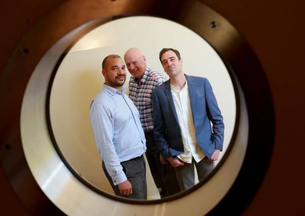 DAC boss Norm Hagarty, centre, with Ambergreen's Tino Nombro, left, and Grant Whiteside. Picture: Stewart Attwood