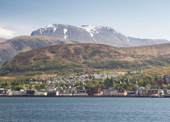 Ben Nevis rises behind Loch Linnhe, with the town of Fort William on the shore. Picture: TSPL