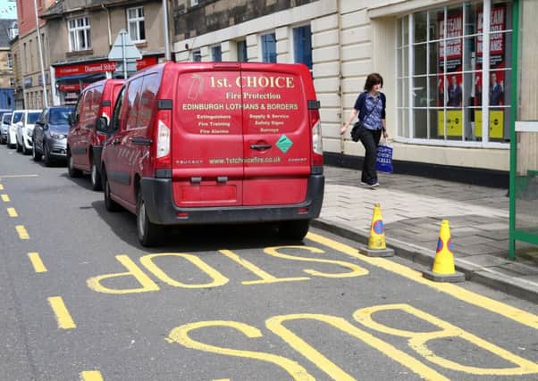 Vans and other vehicles blocking bus stops can cause traffic havoc. Picture: Gordon Fraser