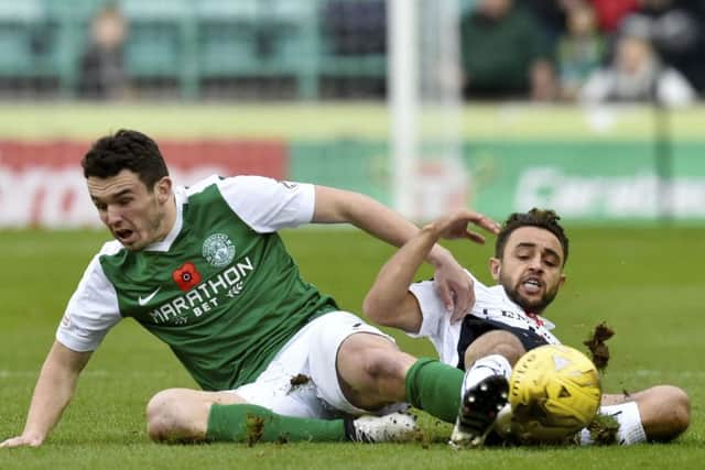 Hibernian's John McGinn (left) slides in to challenge Falkirk's Tom Taiwo. Picture: Rob Casey/SNS