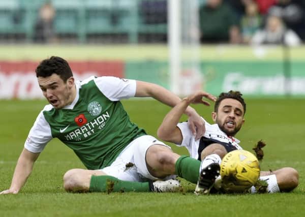 Hibernian's John McGinn (left) slides in to challenge Falkirk's Tom Taiwo. Picture: Rob Casey/SNS