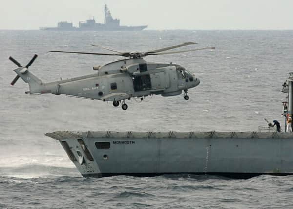 A British helicopter lands on the deck of the Royal navy frigate Monmouth during exercises. (Photo: Getty Images)
