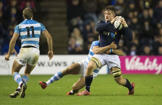 Scotland's Magnus Bradbury (right) is tackled by Matias Moroni. Picture: SNS
