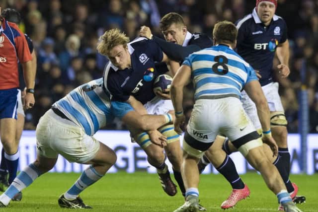 Scotland's Jonny Gray (centre) is tackled by Pablo Matera. Picture: SNS